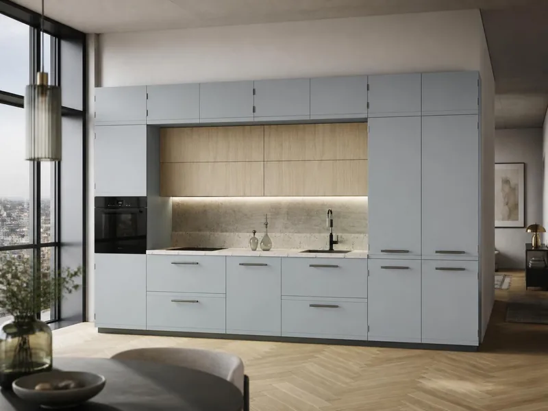 Cuisine Nebbia : linéaire, façades laquées mates gris bleuté, éléments hauts décor chêne clair, plan effet pierre ; électroménager en option